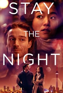 The image shows the promotion image of the movie Stay The Night. The image shows Grace and the stranger with the skyline of Newyork in the background. 